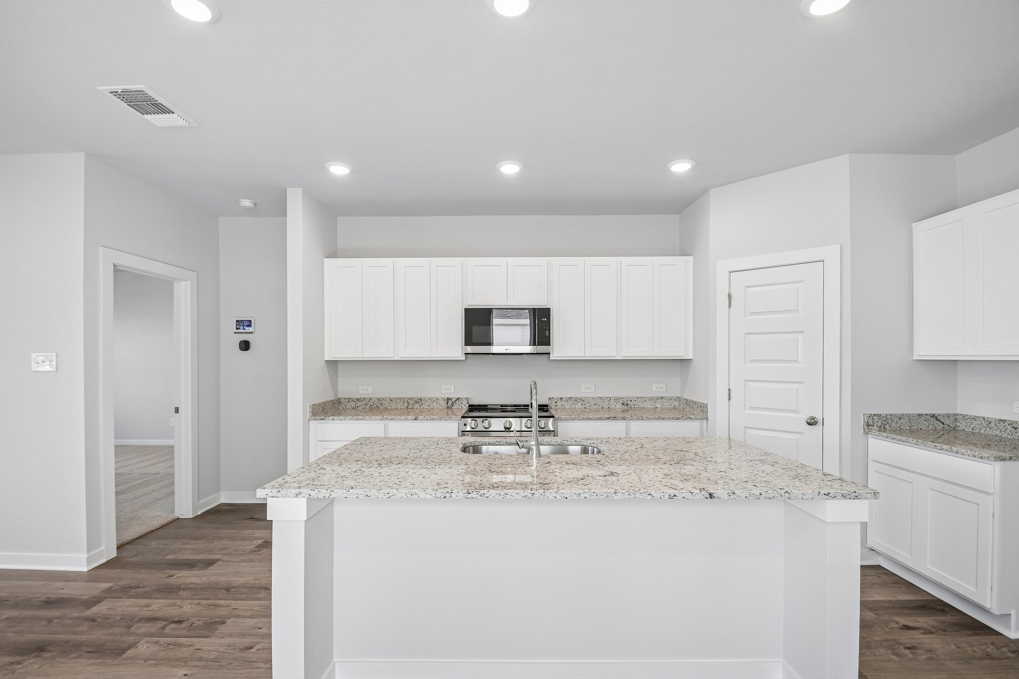 A kitchen with white cabinets.