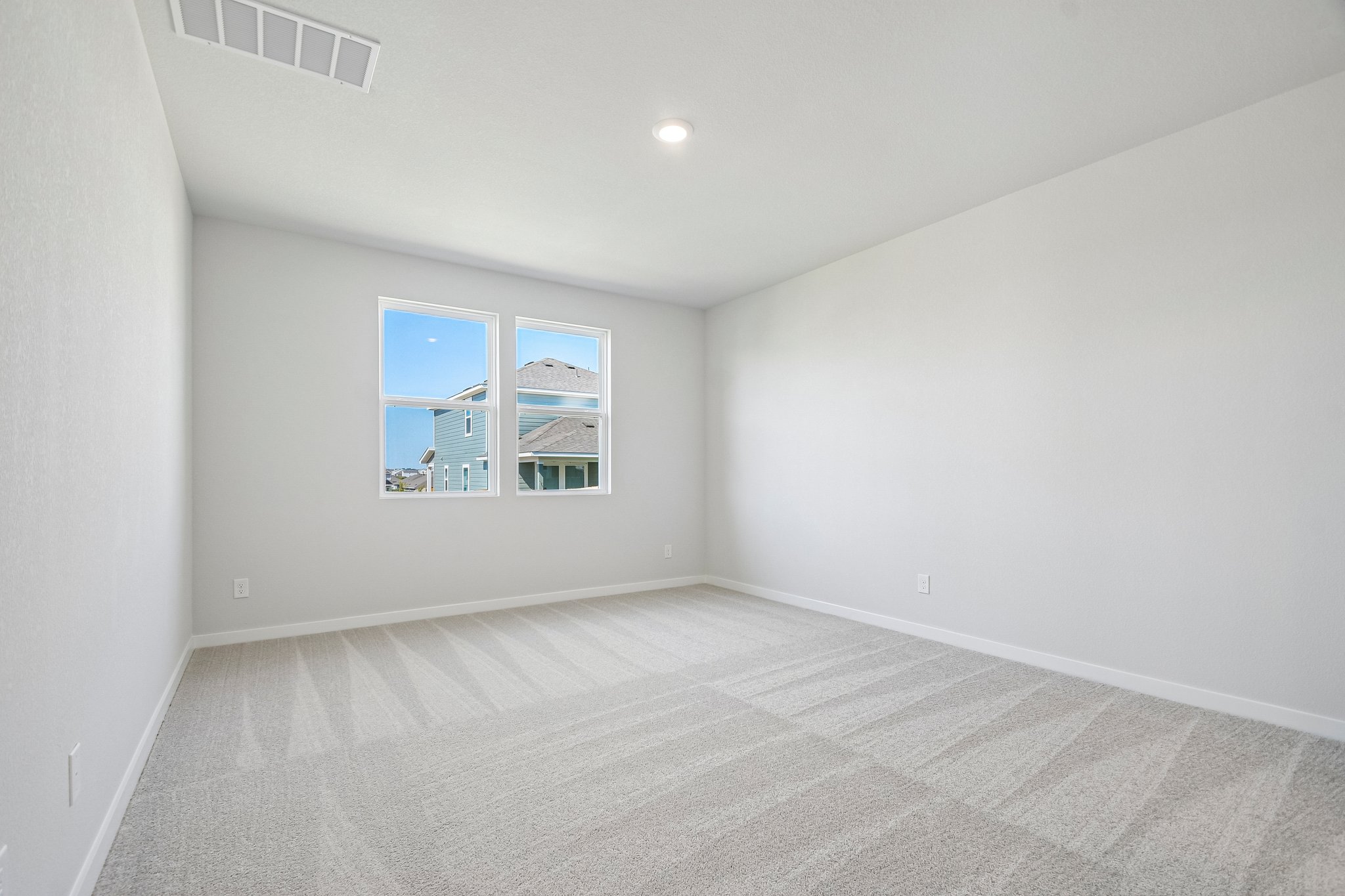 A room with a window and a carpet.