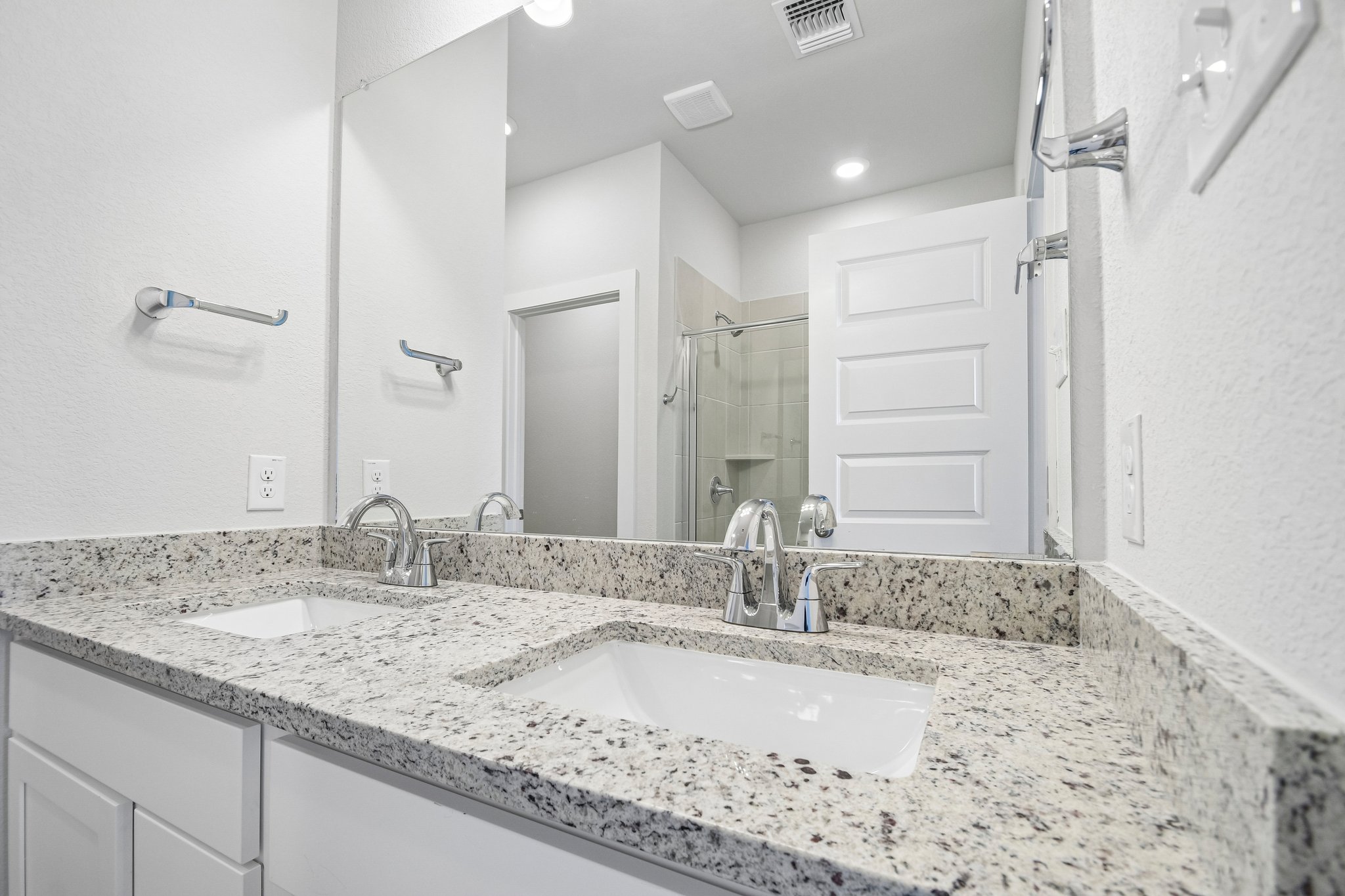 A bathroom with a marble countertop.