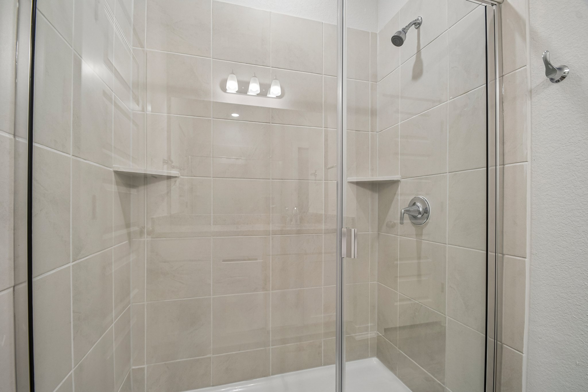 A shower with a glass door.