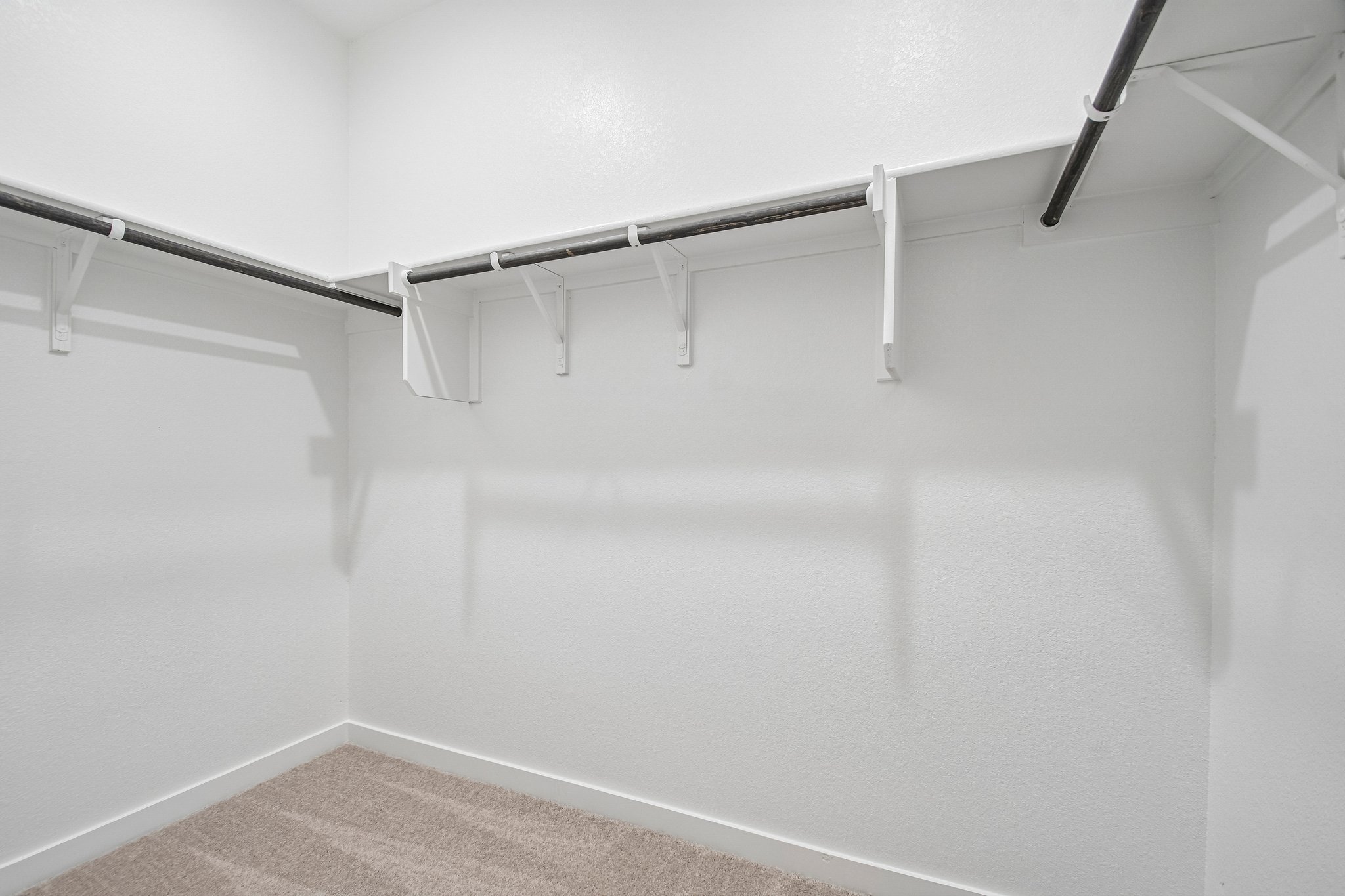 A white wall with a metal railing.