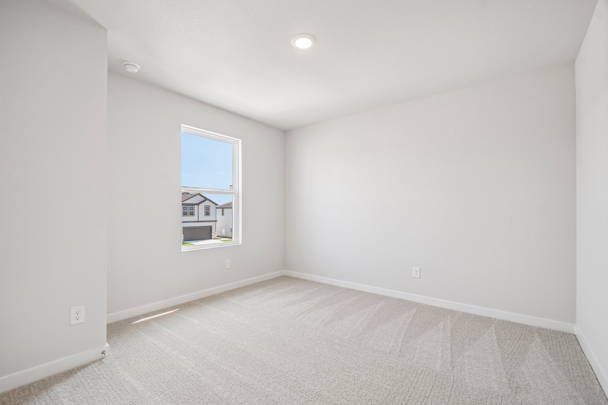 A room with a window and a carpet.