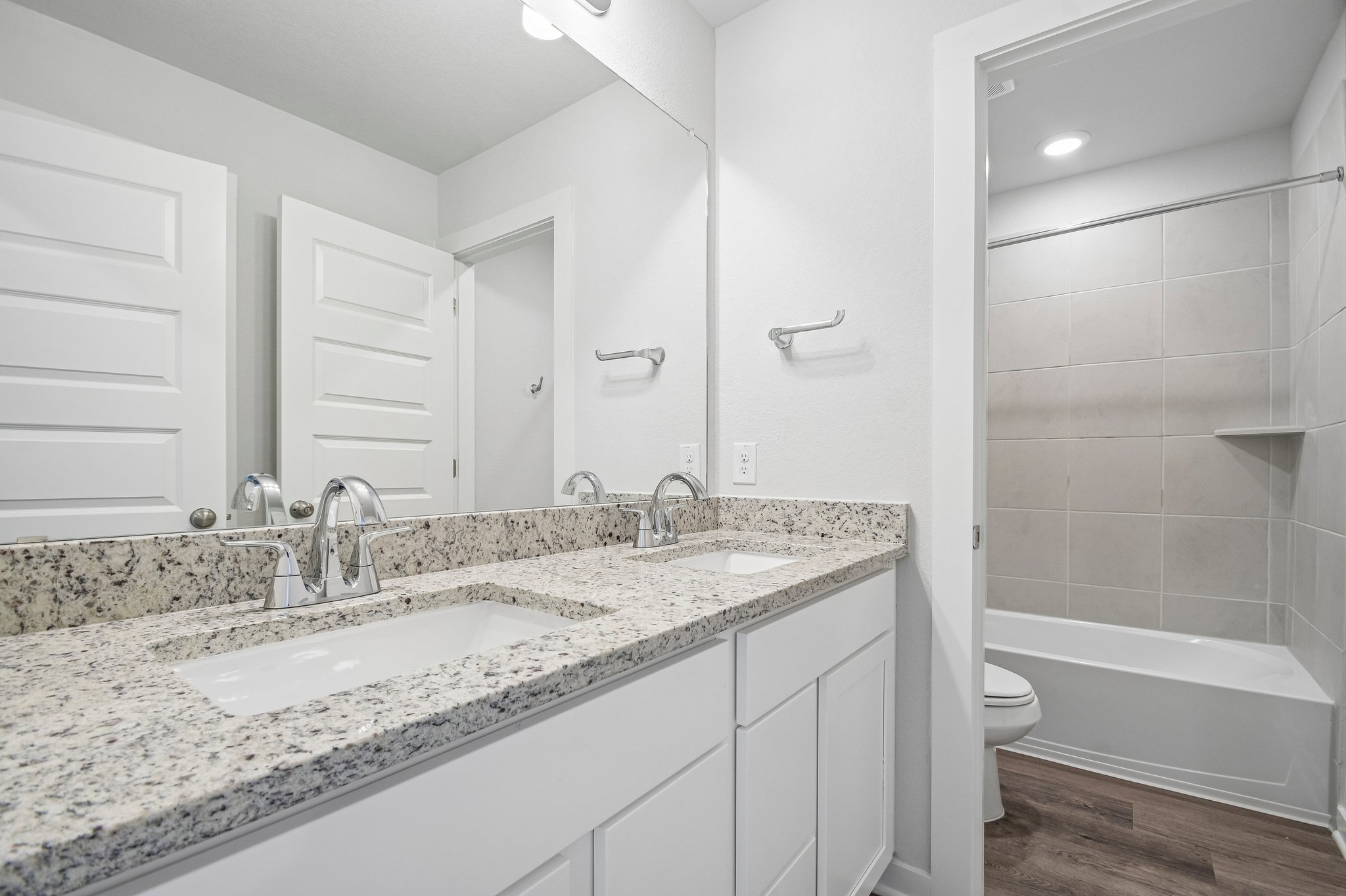 A bathroom with a marble countertop.