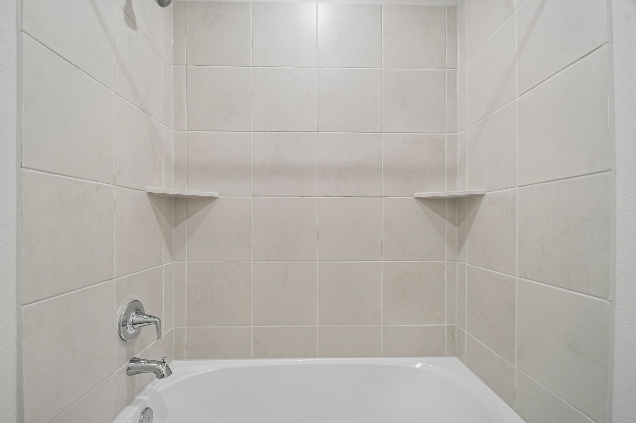 A bathtub in a bathroom.
