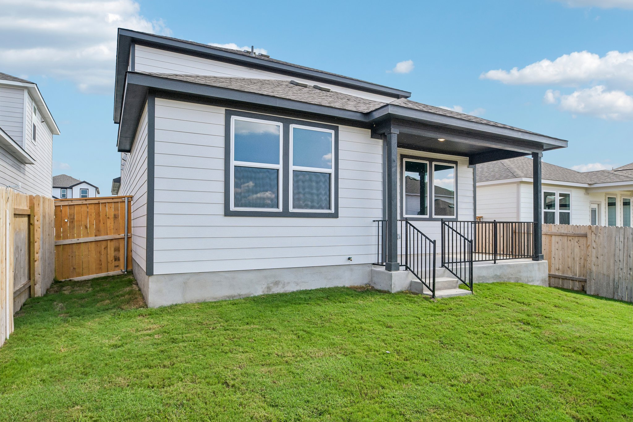A house with a fence and grass.