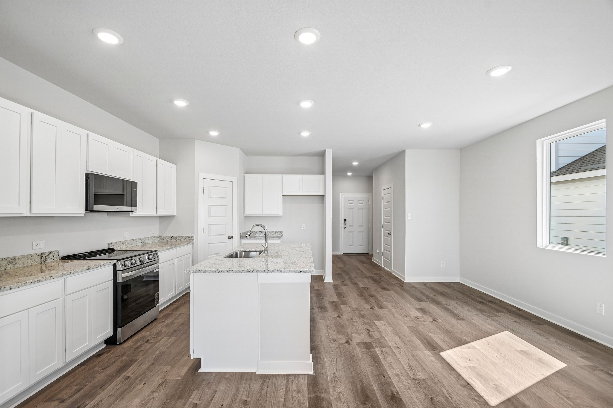 A kitchen with white cabinets.