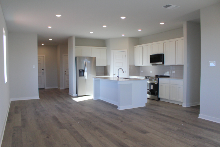 A kitchen with white cabinets.