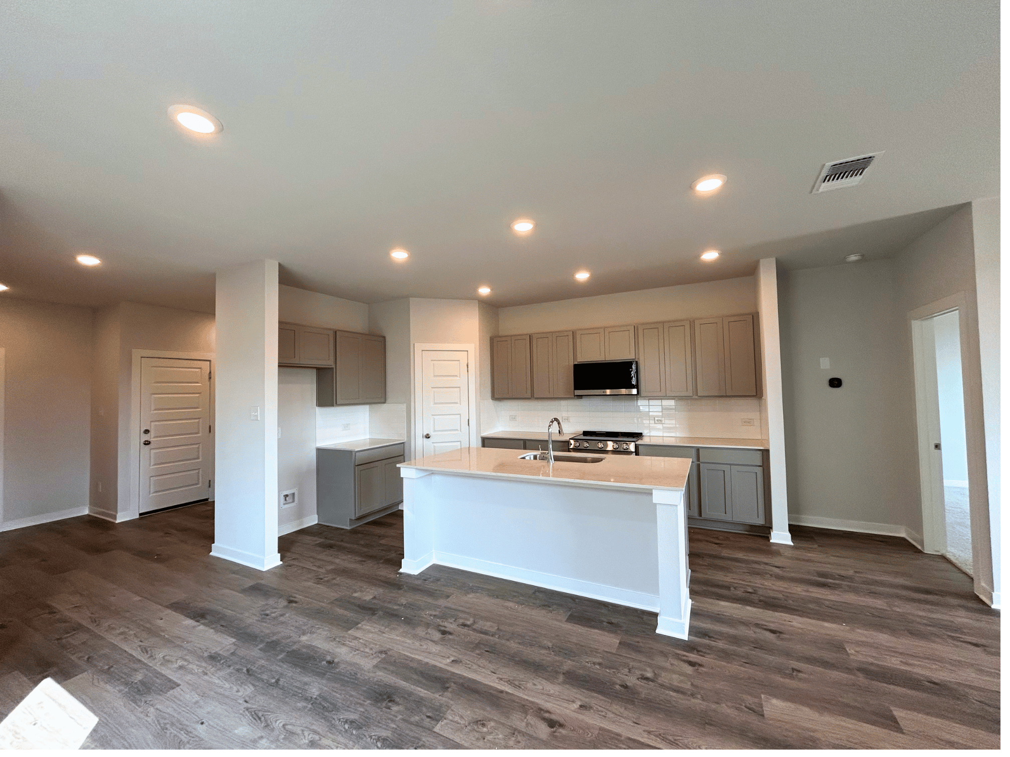 A kitchen with white cabinets.
