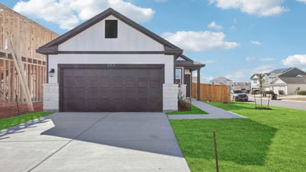 A white house with a garage.
