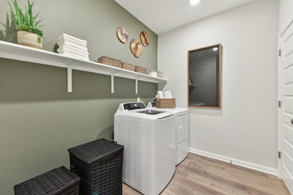 A kitchen with a white stove and shelves.