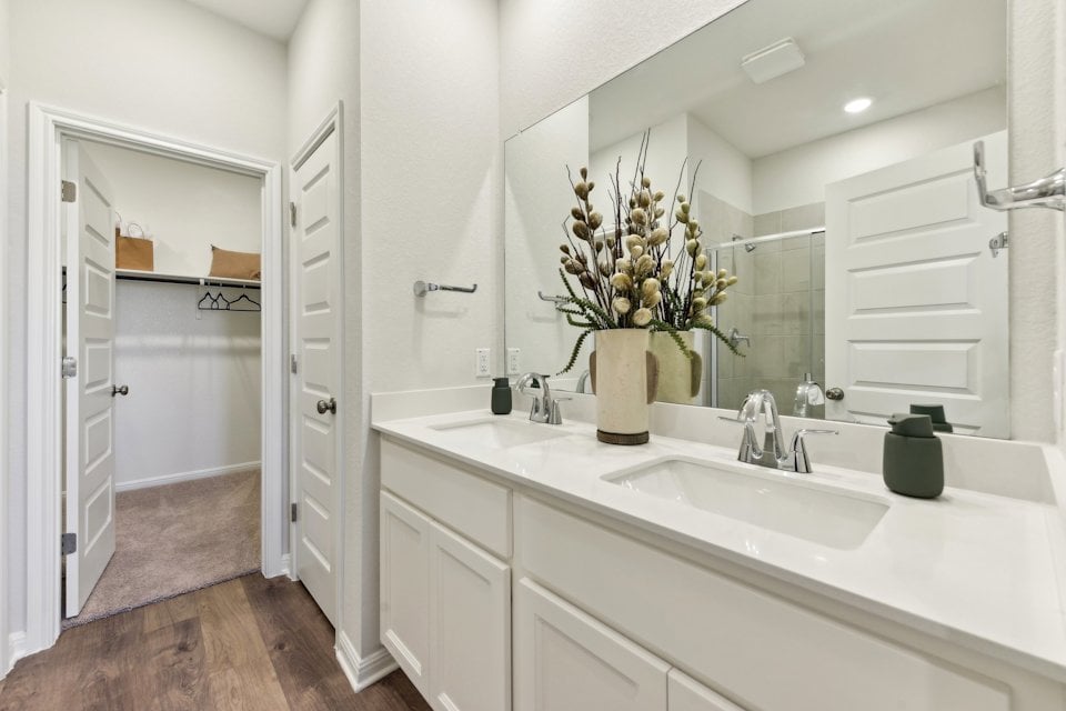 A bathroom with a large mirror.