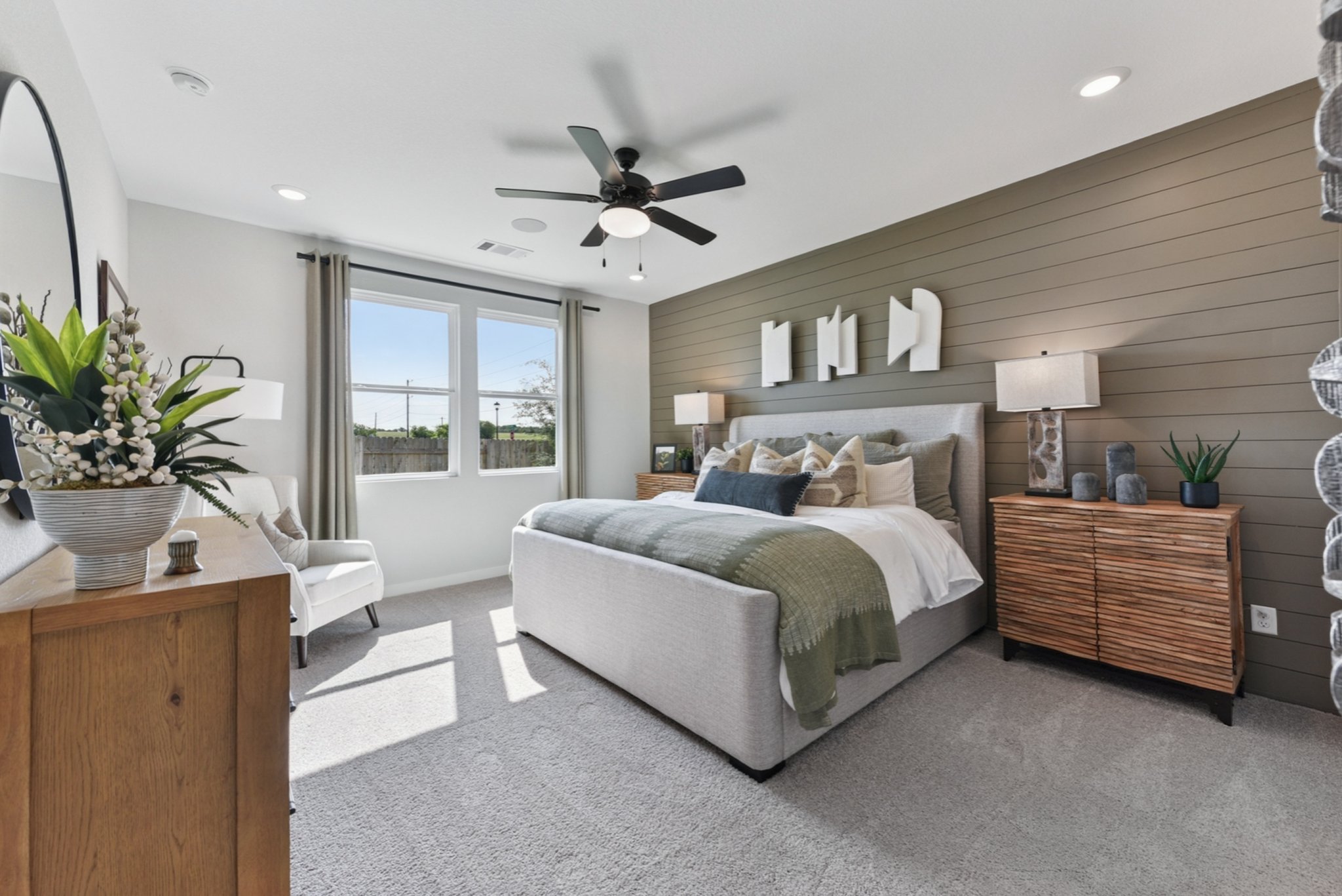 A bedroom with a bed and a fan.