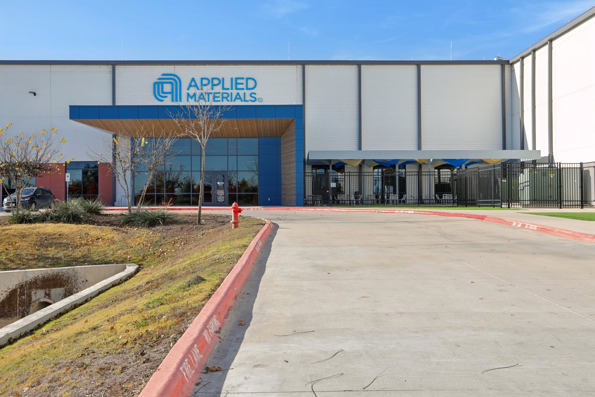 A building with a red fire hydrant in front.