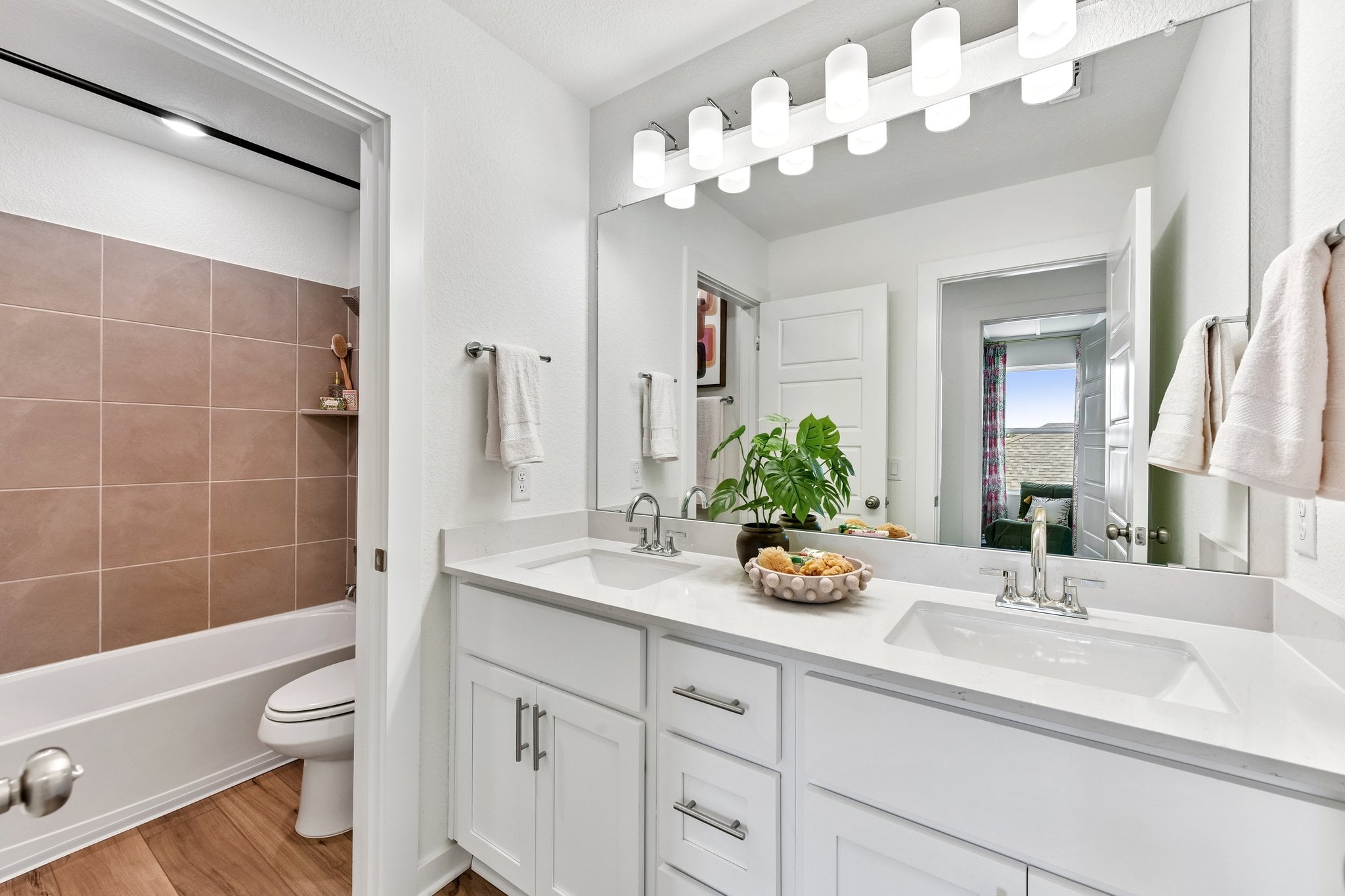 A bathroom with a tub sink and toilet.