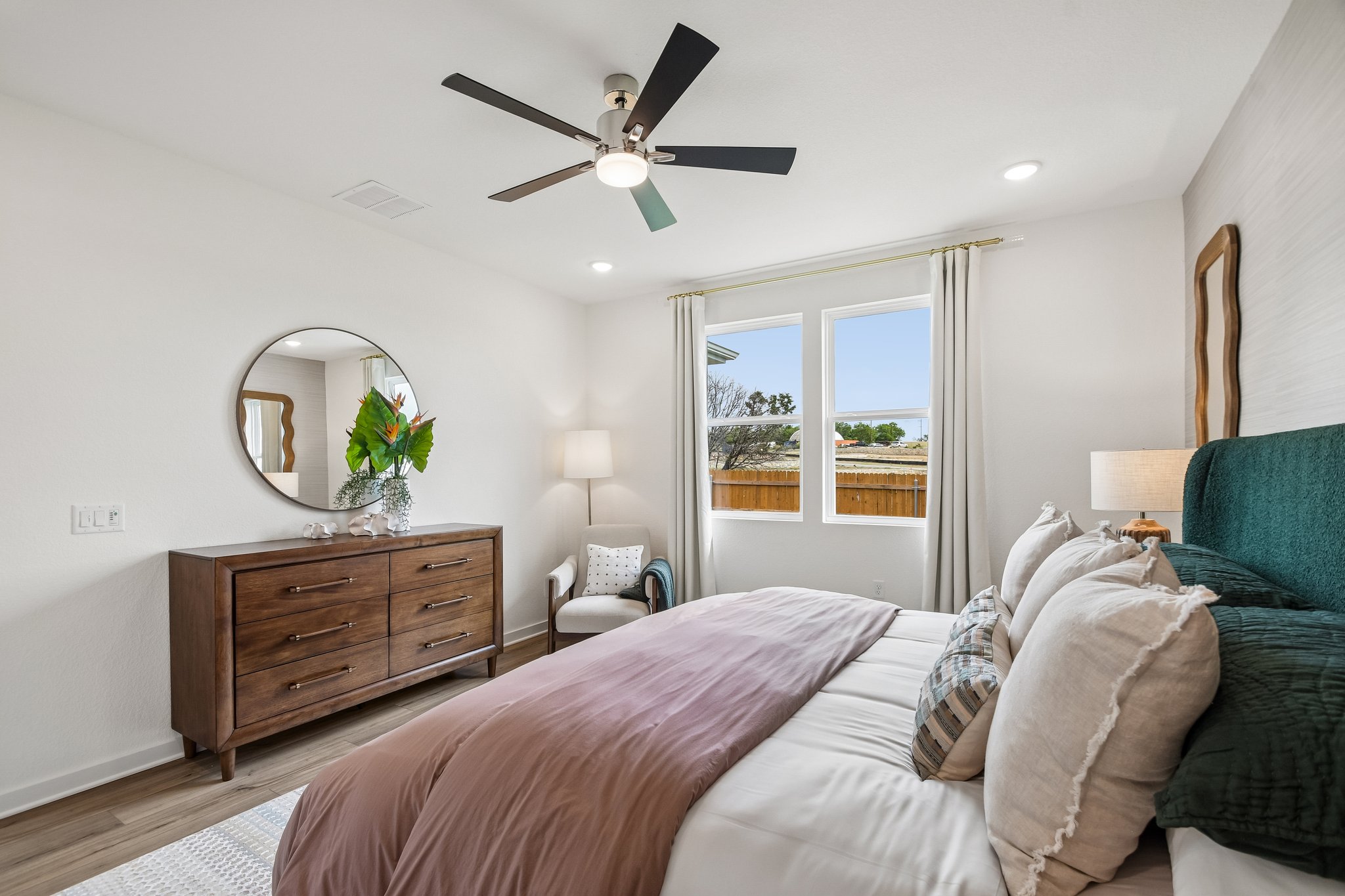A bedroom with a large window.