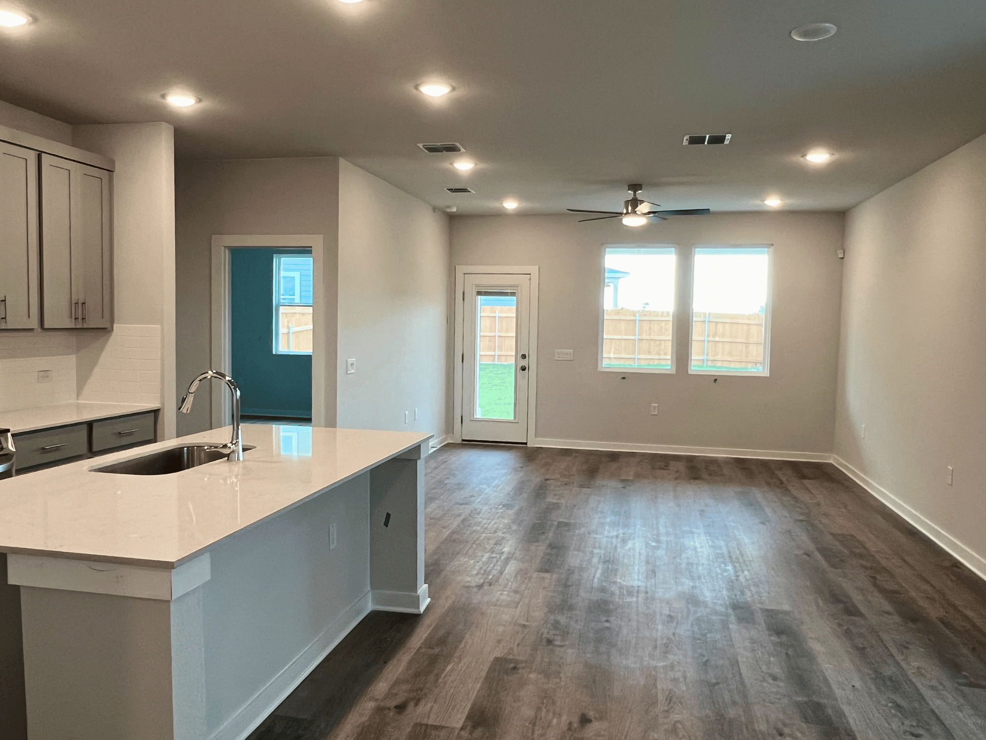 A kitchen with a wood floor.