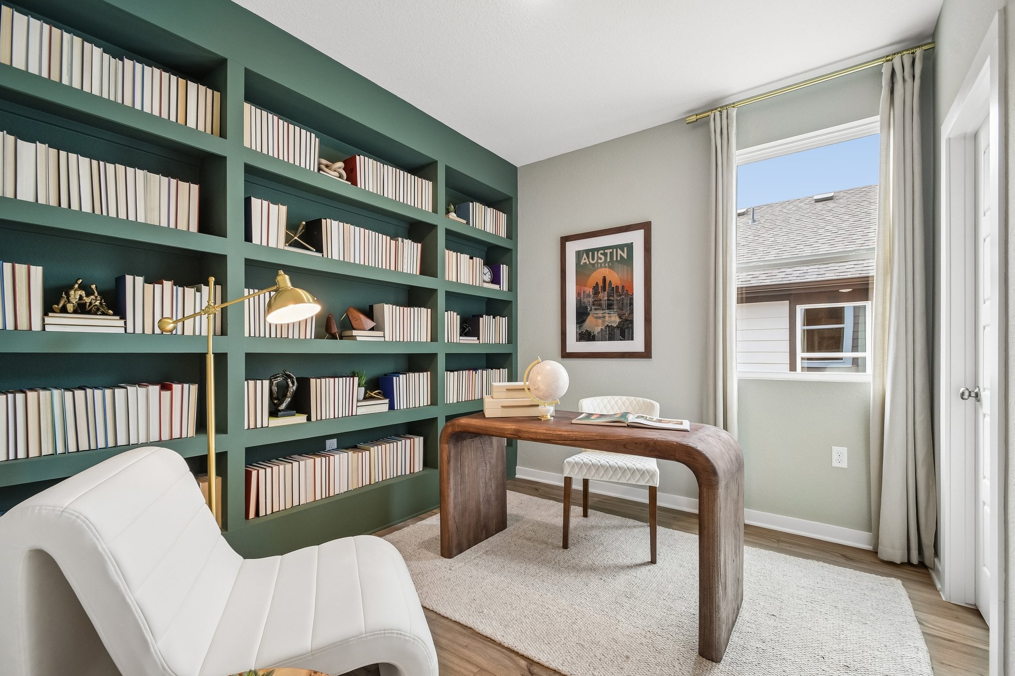 A room with a table and bookshelves.