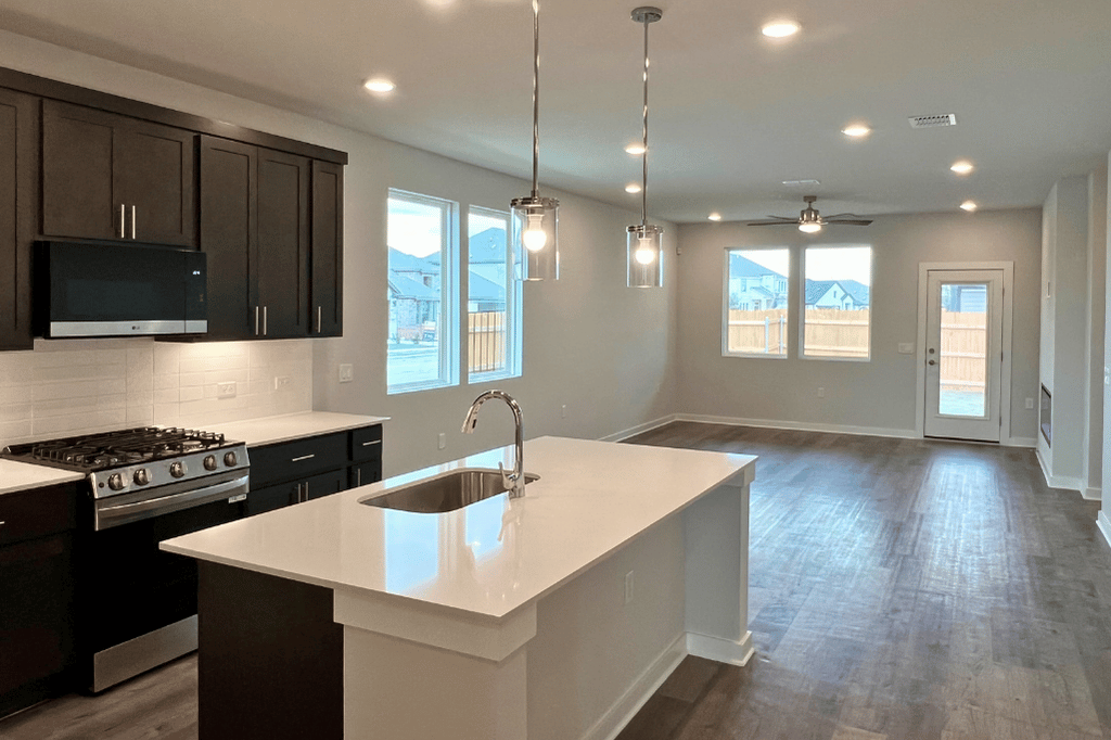 A kitchen with black cabinets.