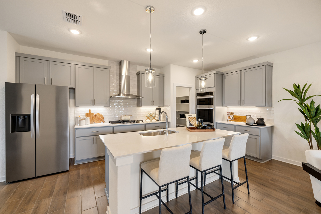 A kitchen with white cabinets.