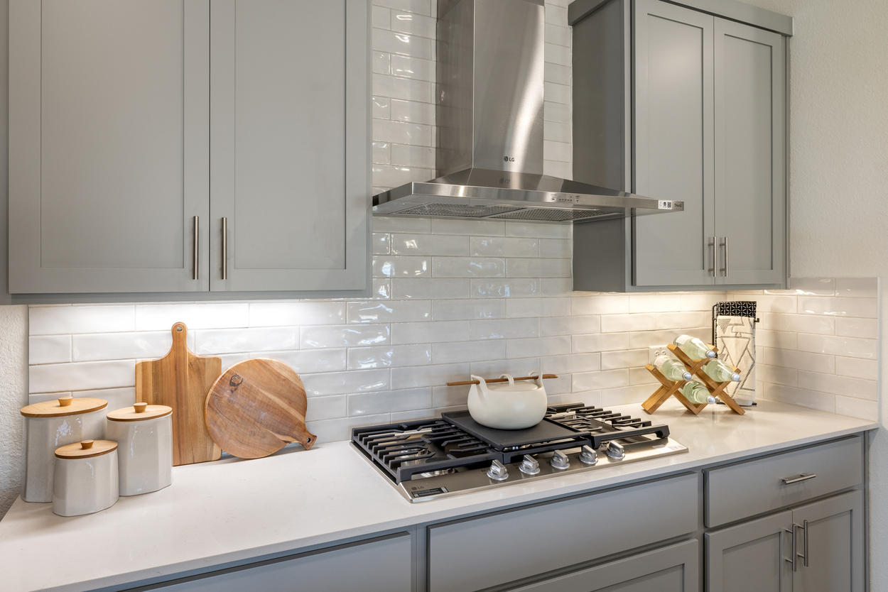 A kitchen with white cabinets.