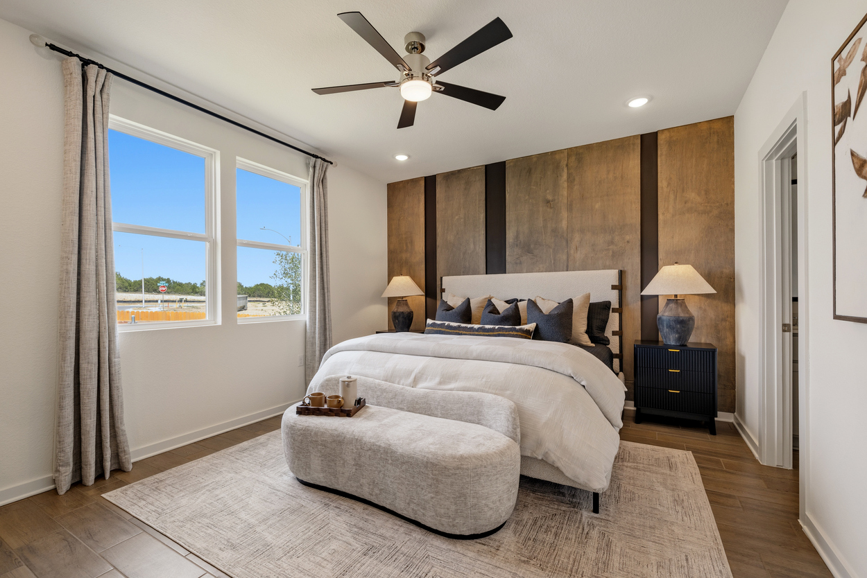 A bedroom with a large bed and a large window.