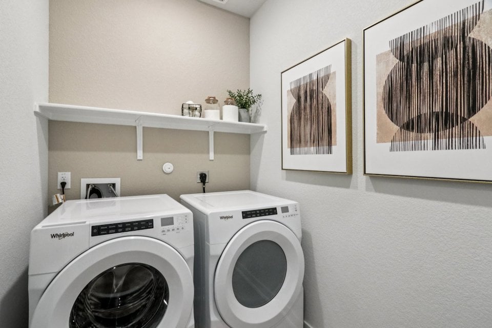 A washing machine and dryer in a room.