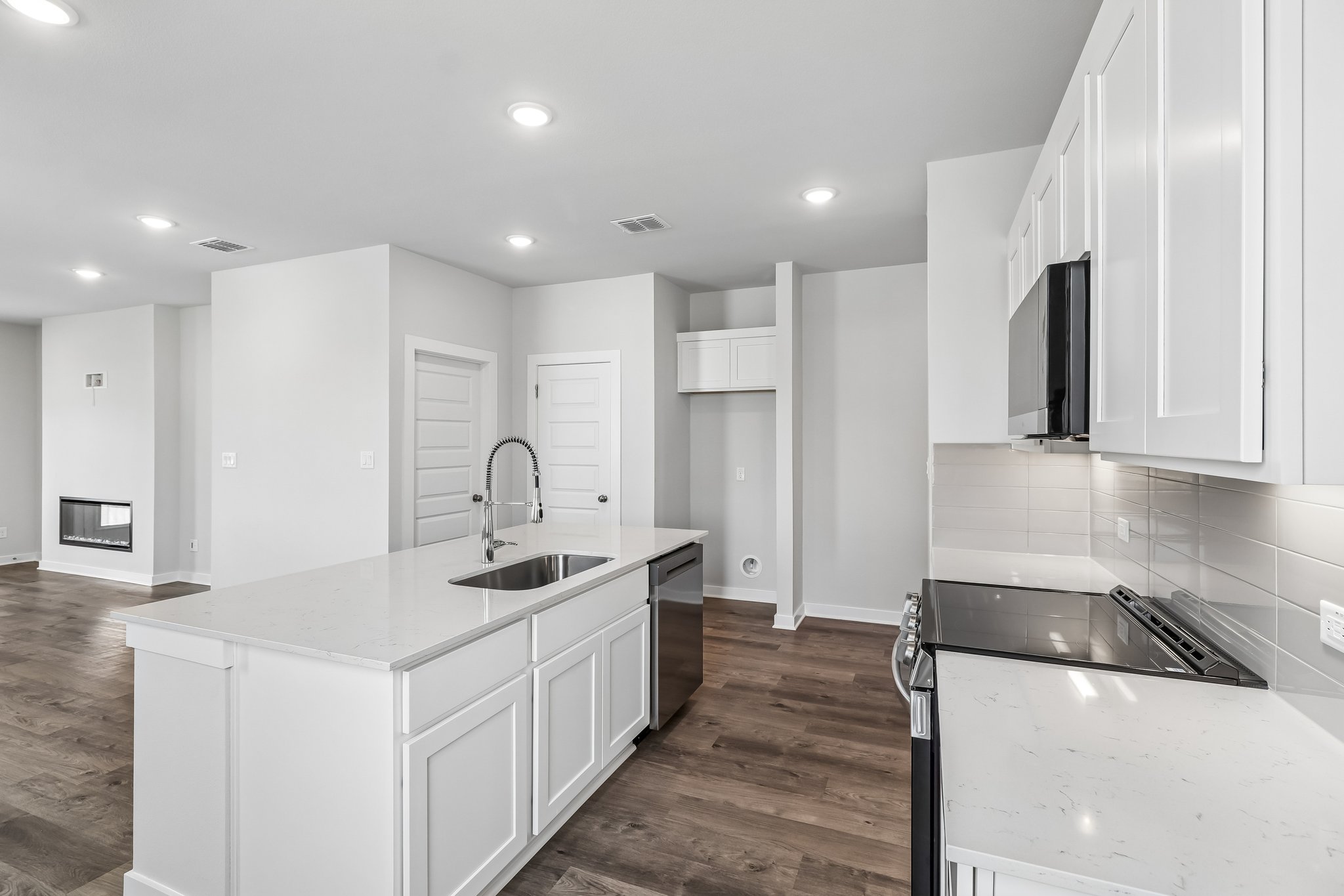 A kitchen with white cabinets.
