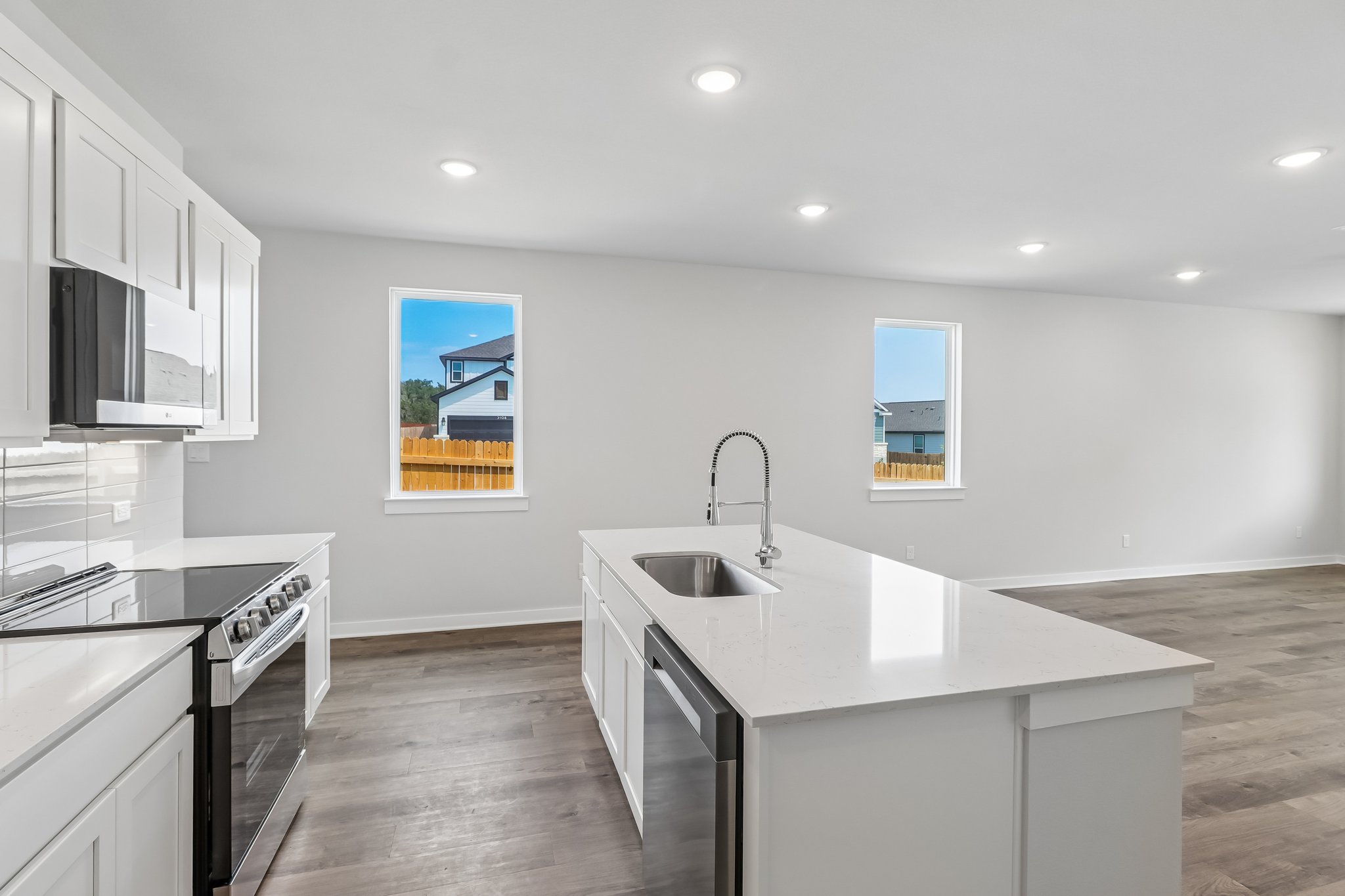 A kitchen with white cabinets.
