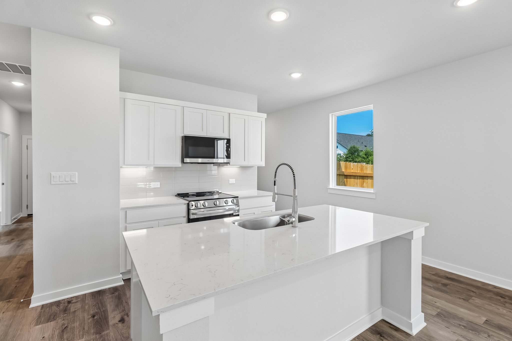 A kitchen with white cabinets.