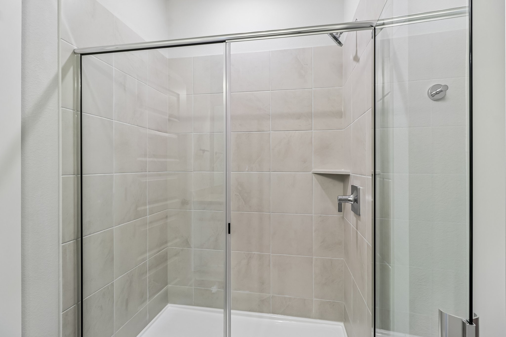 A shower with a glass door.