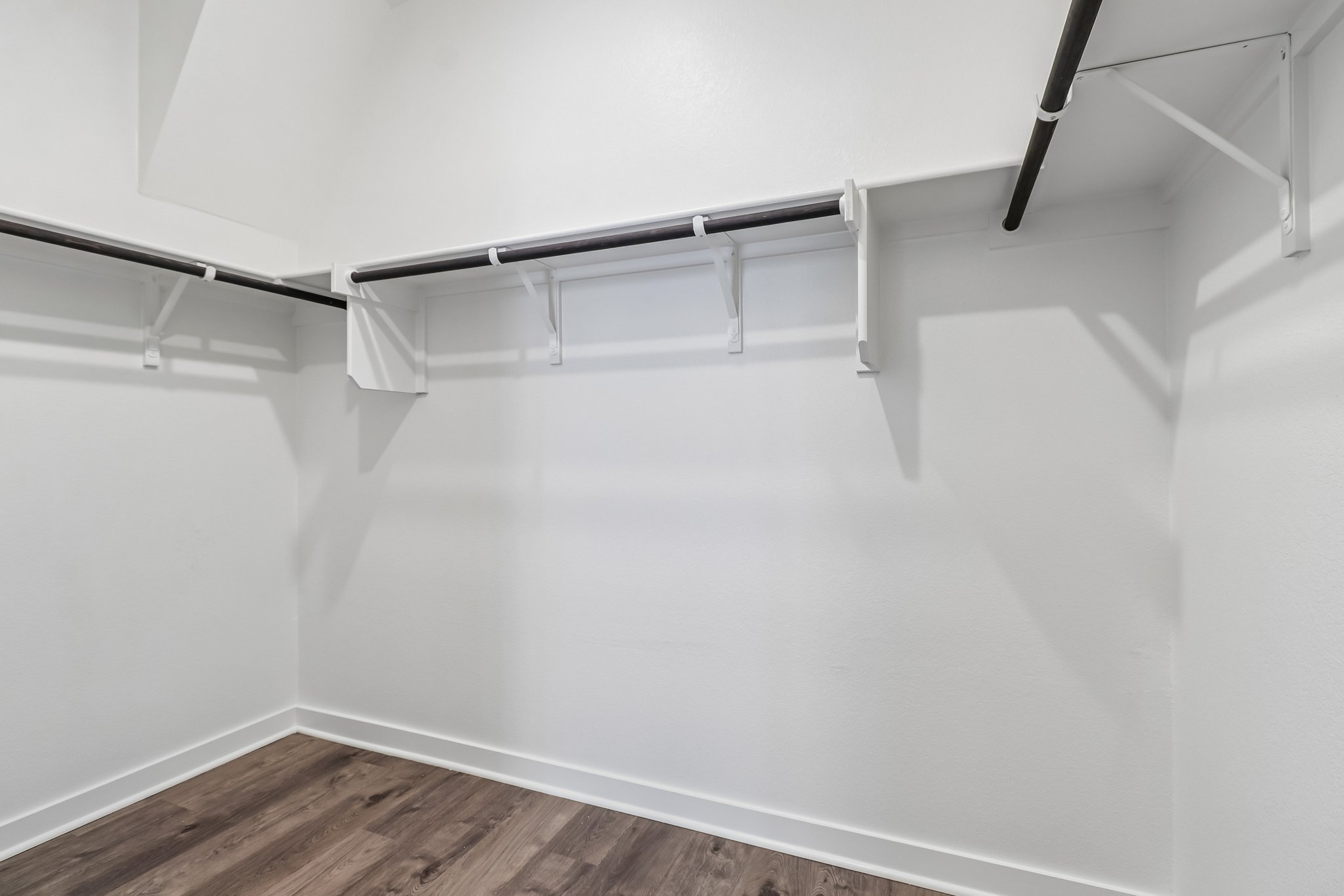 A white staircase with a wooden floor.