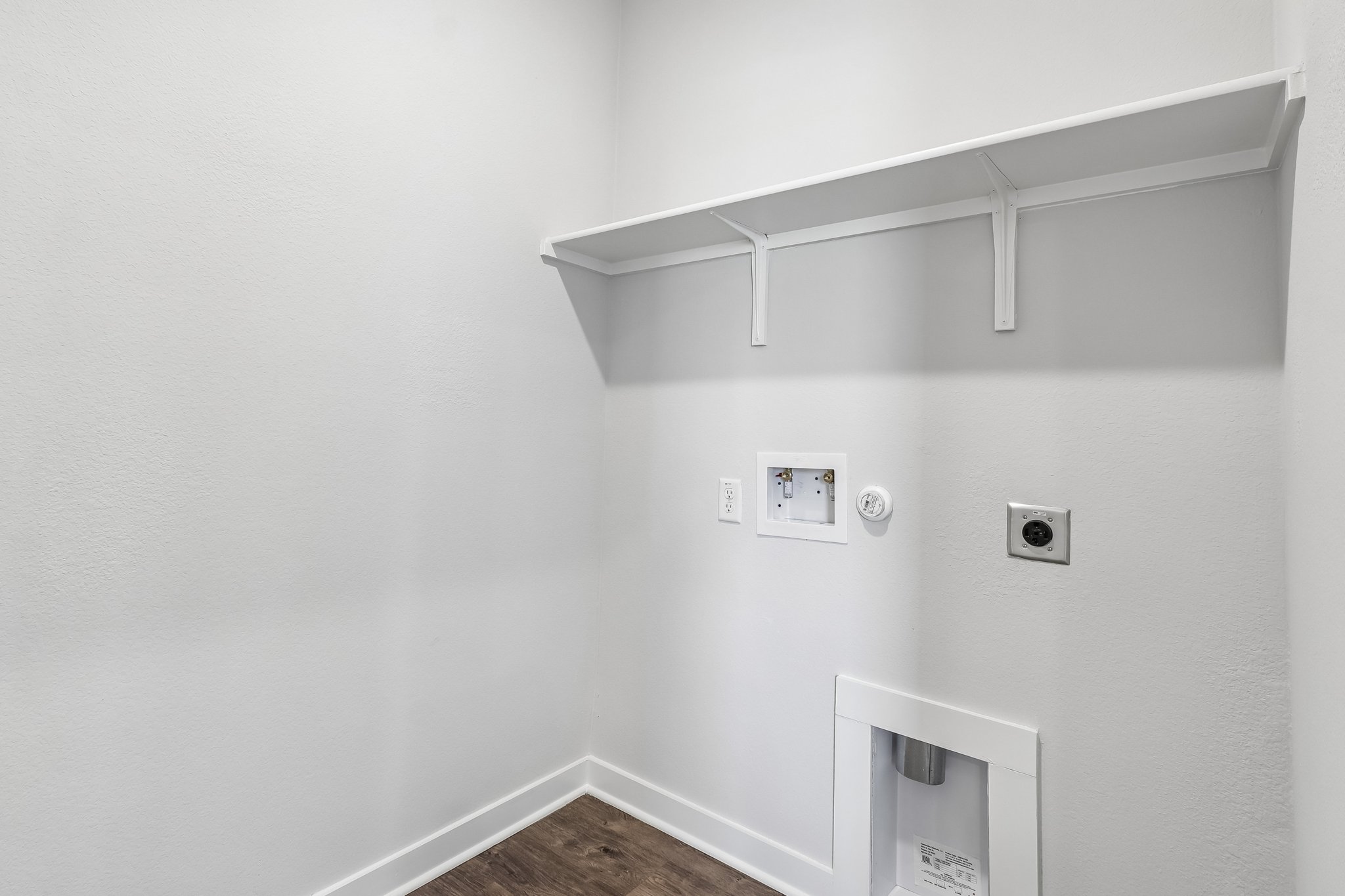 A white wall with a light fixture.