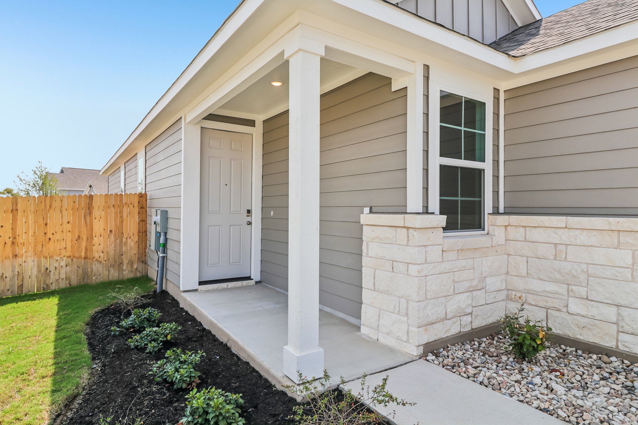 A house with a stone patio.
