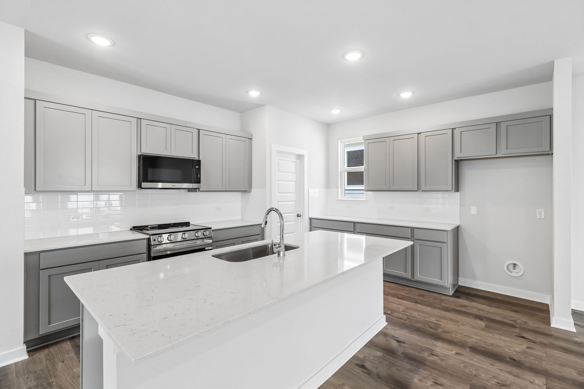 A kitchen with white cabinets.