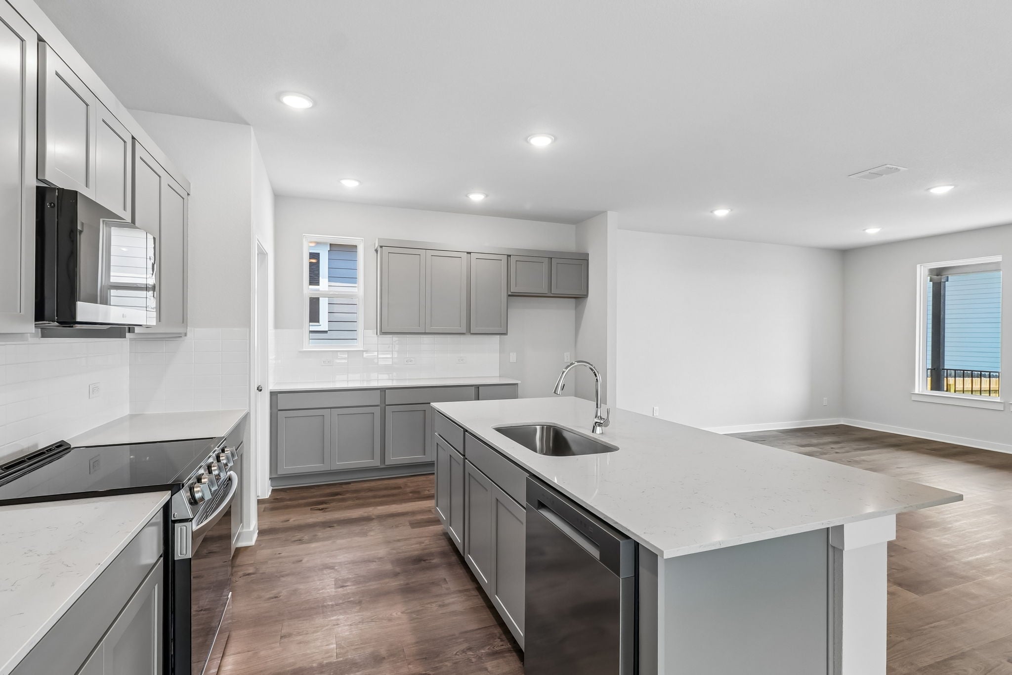 A kitchen with white cabinets.