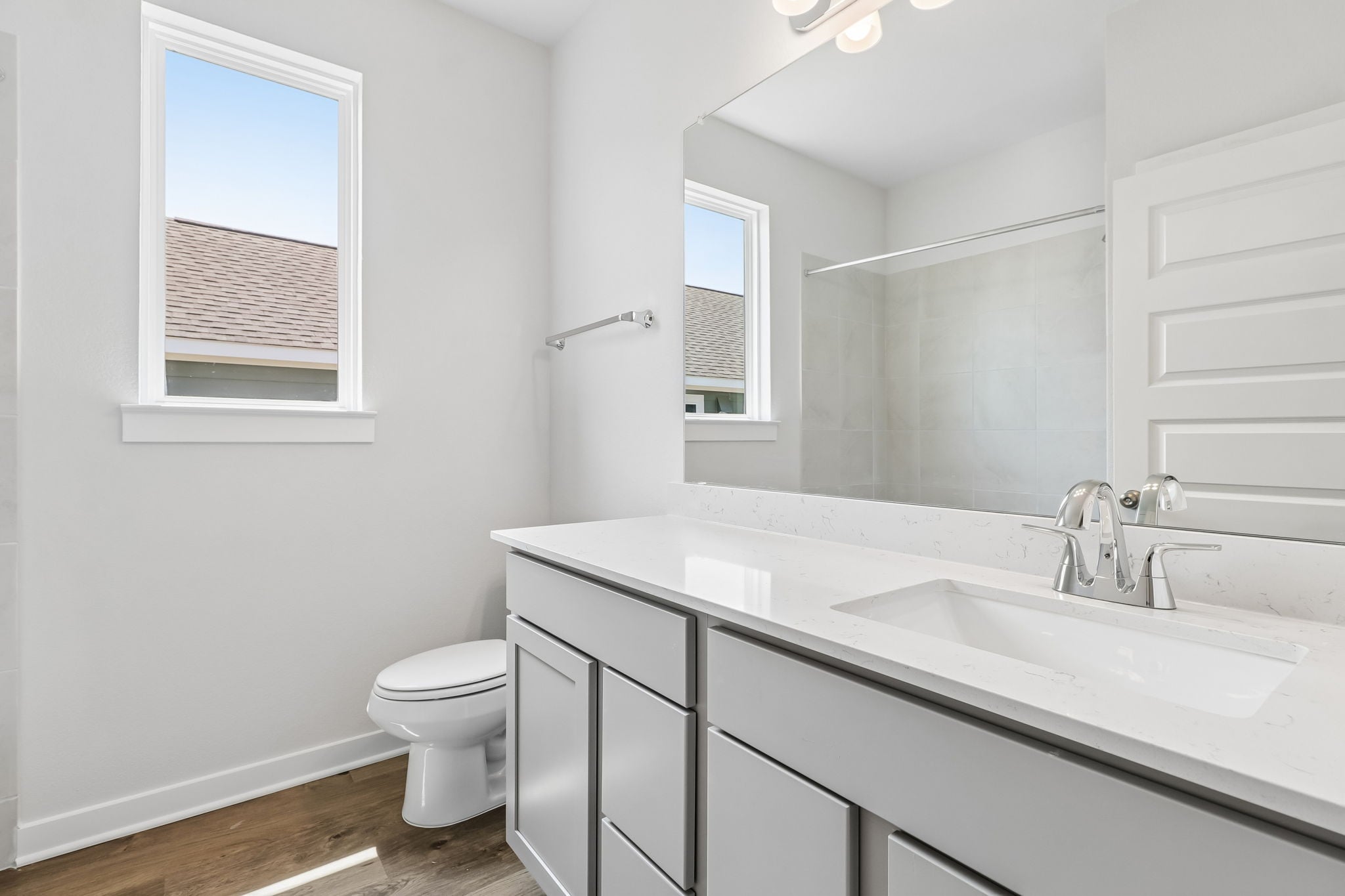 A bathroom with a large mirror.