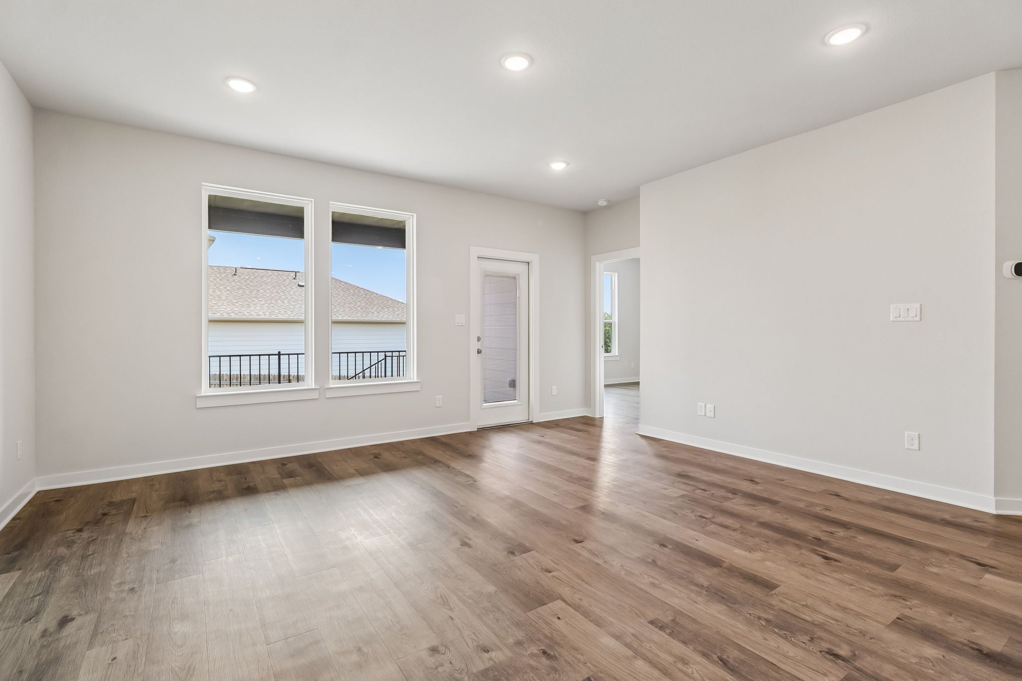 A room with a wood floor and a window.