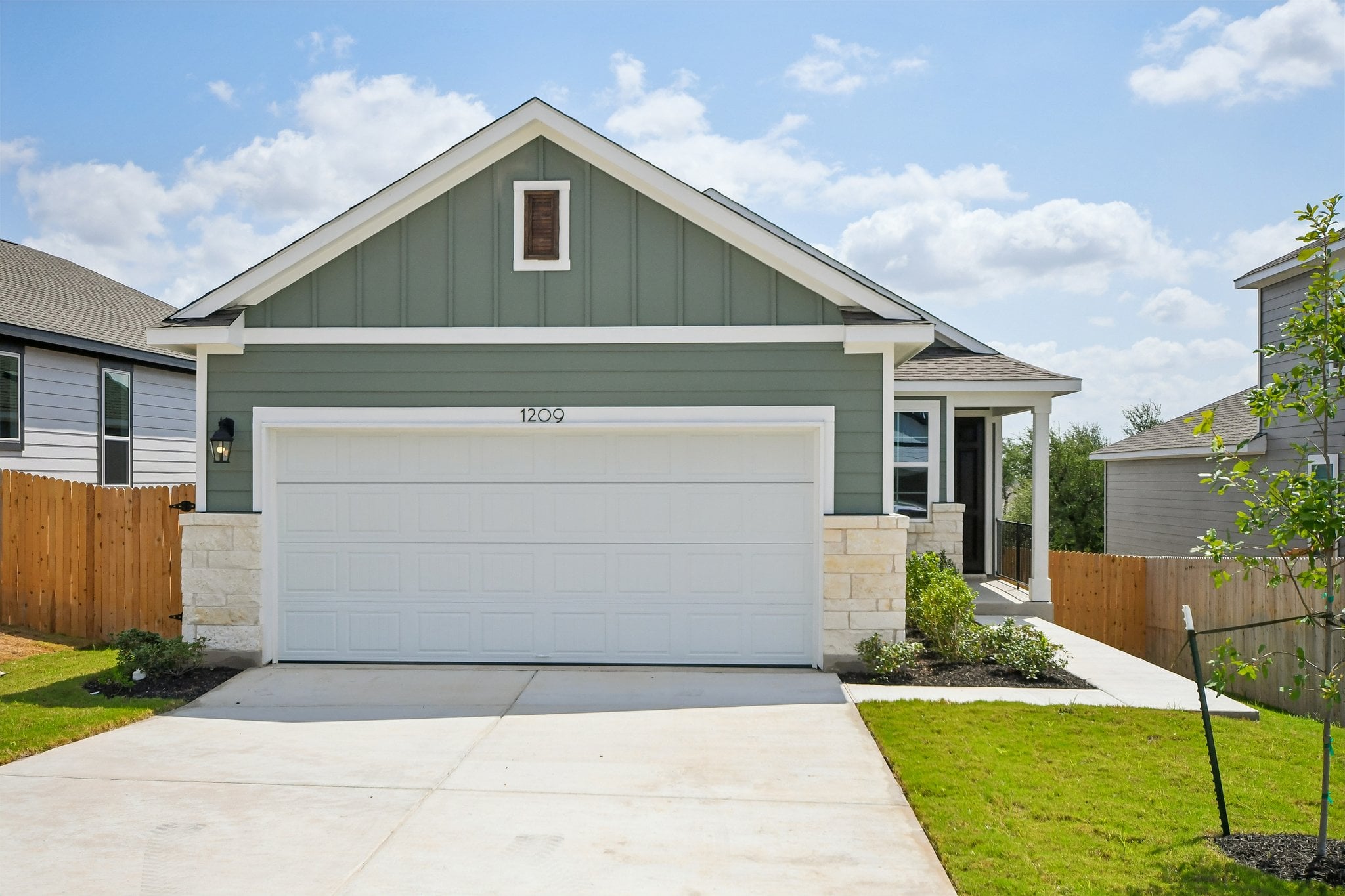A house with a garage with American Gothic House in the background.