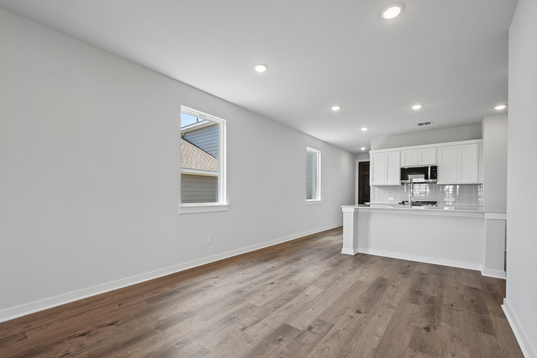 A kitchen with white cabinets.