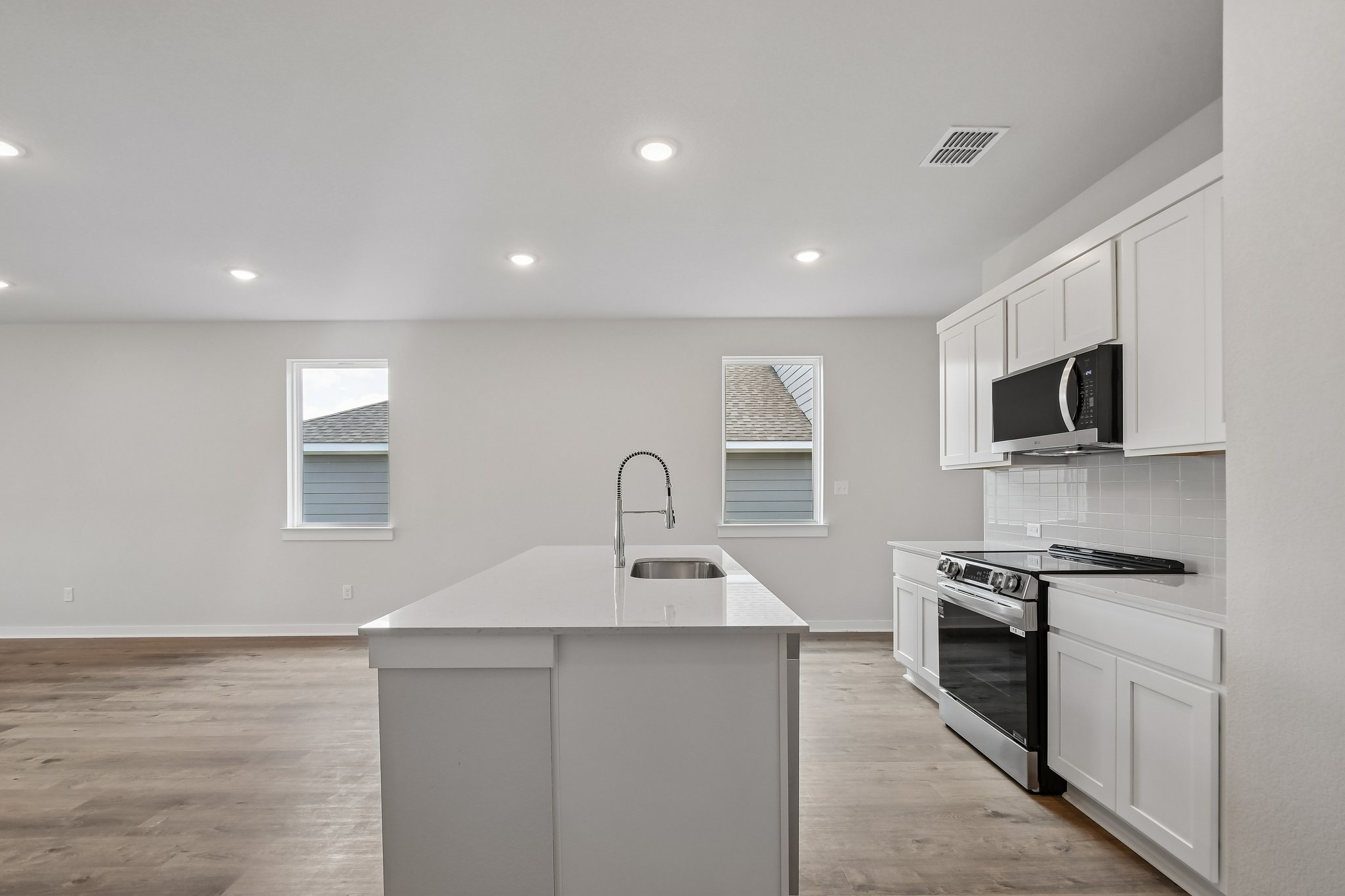 A kitchen with white cabinets.