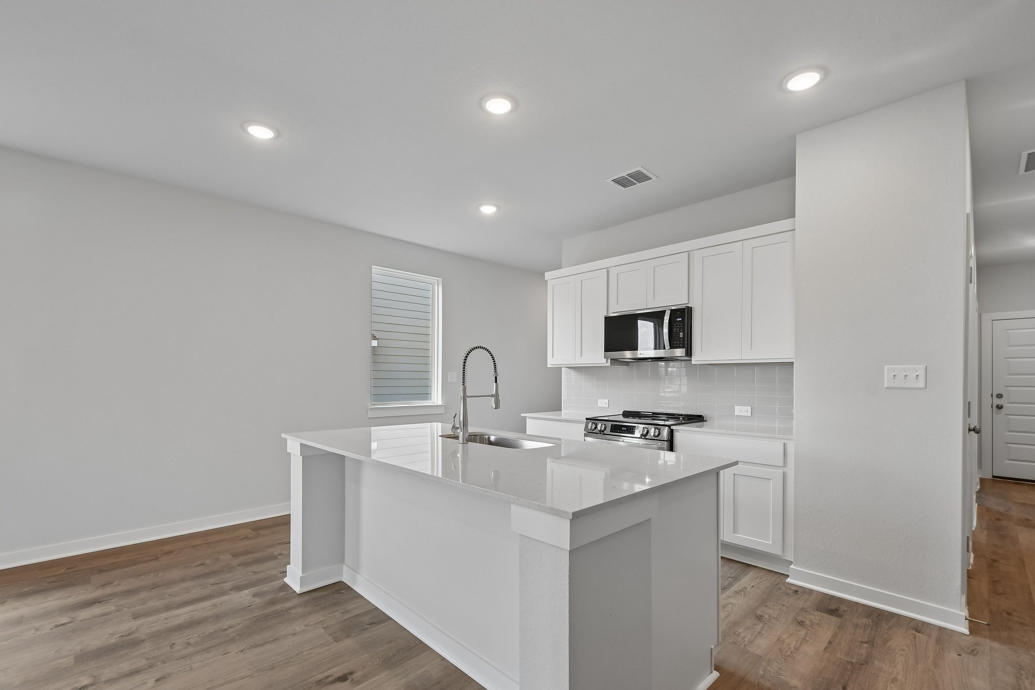 A kitchen with white cabinets.