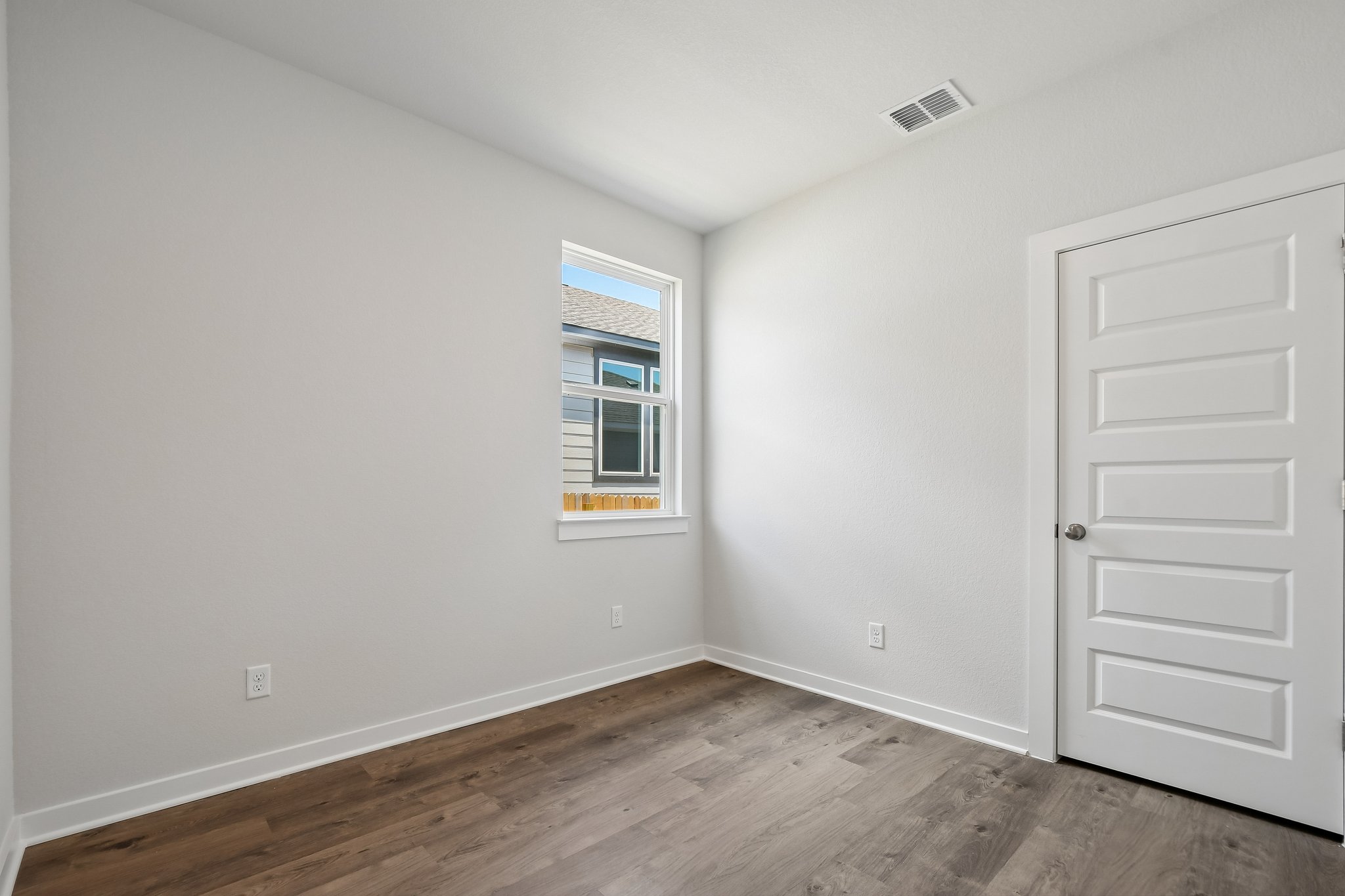 A room with a door and a window.