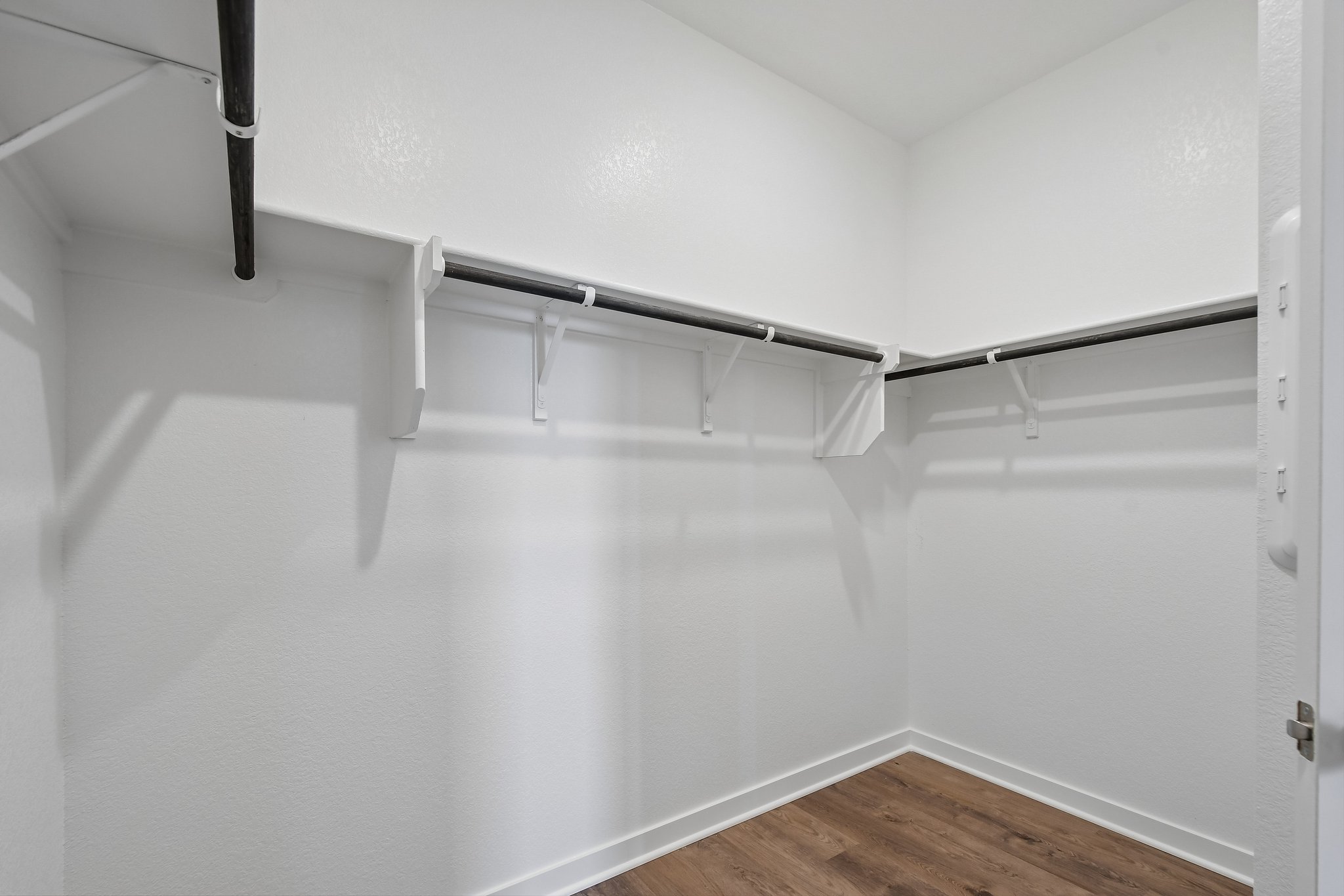 A white room with a wood floor.