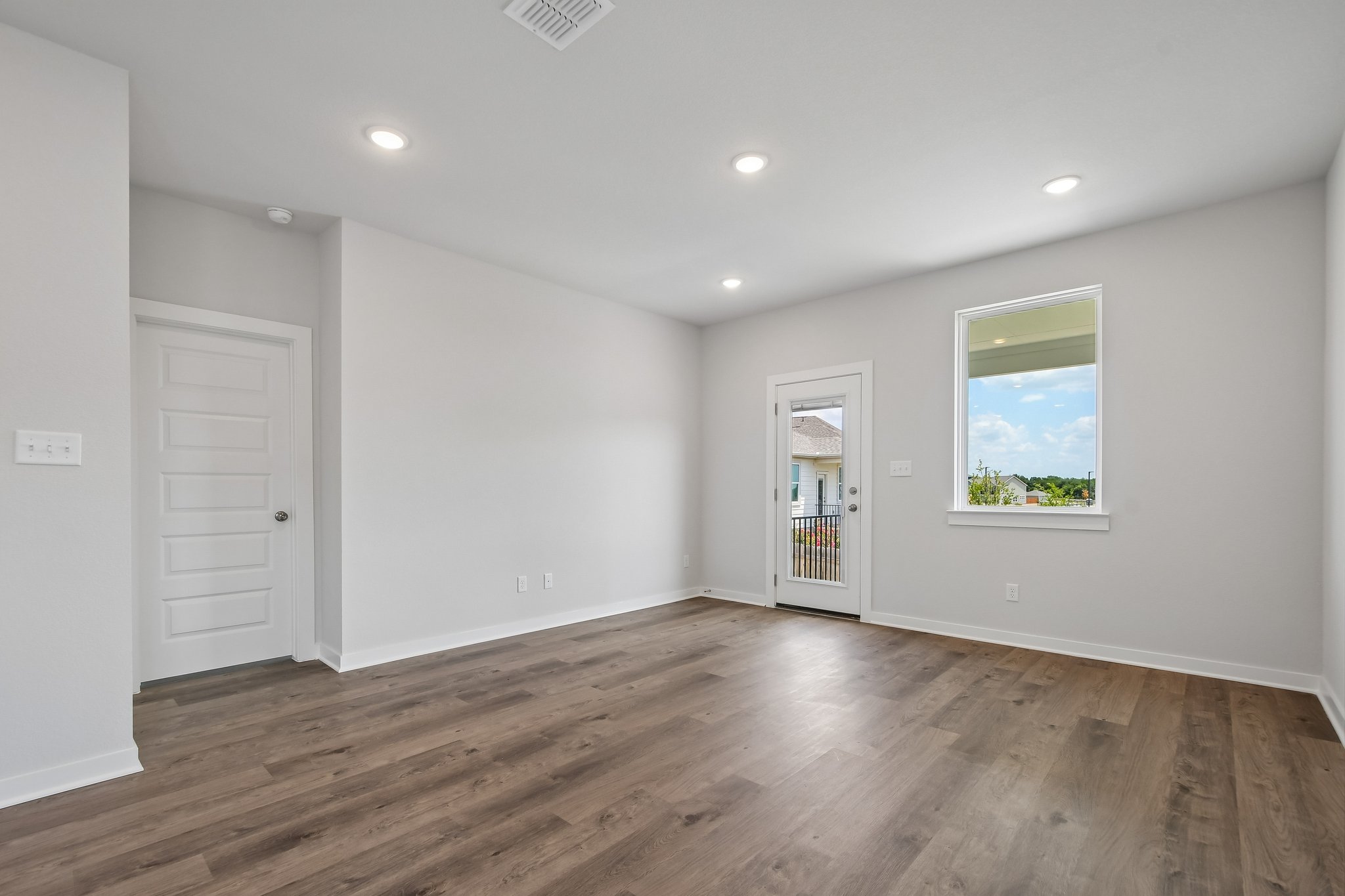 A room with white walls and a wood floor.