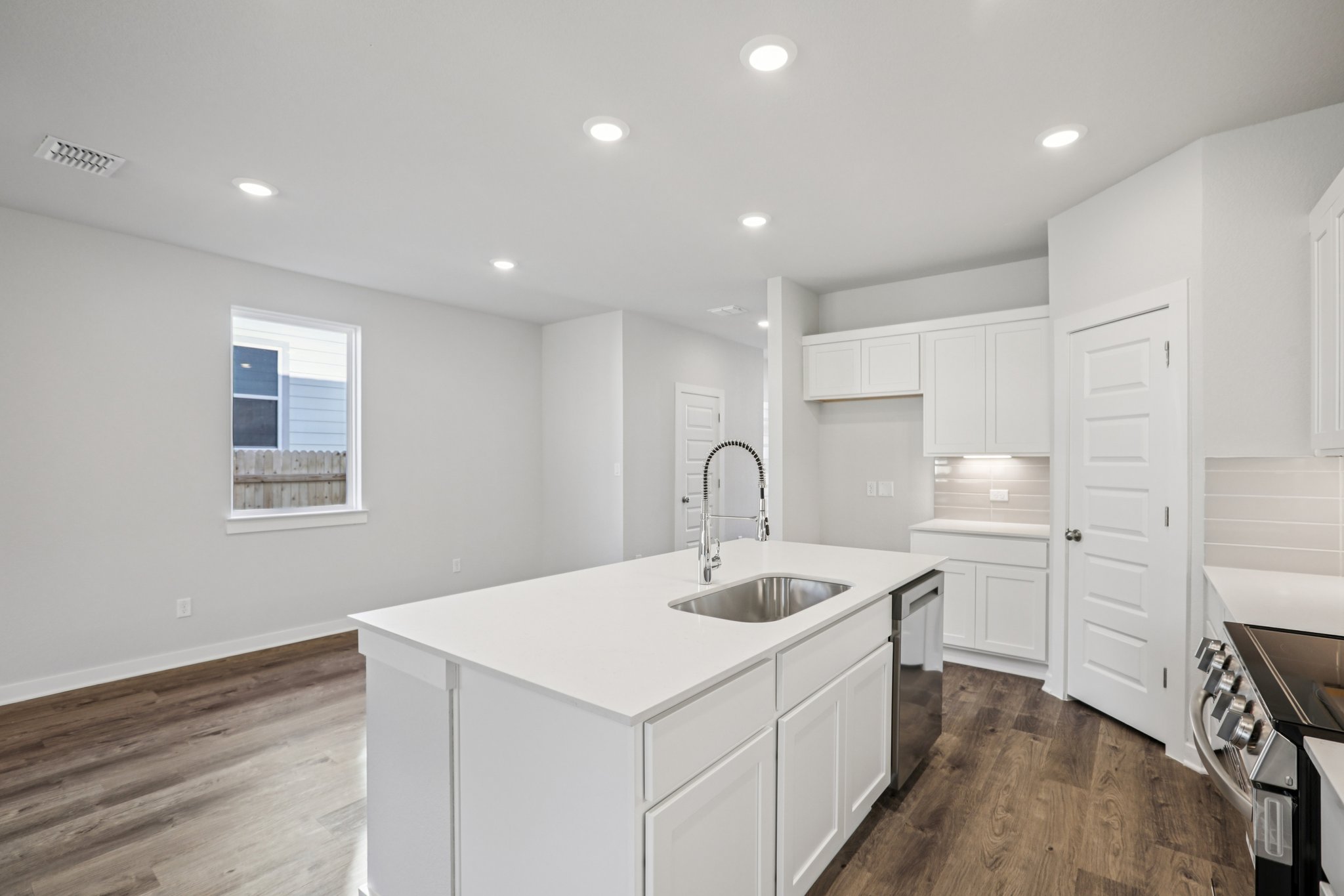 A kitchen with white cabinets.