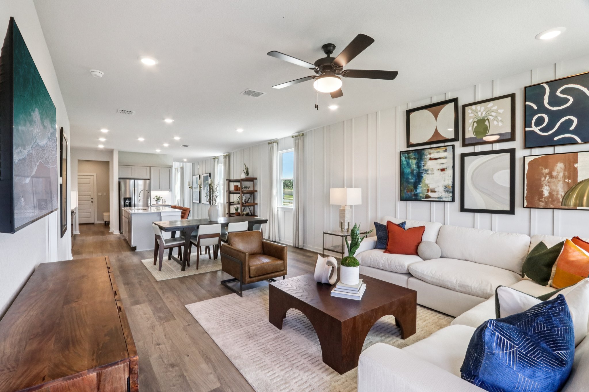 A living room with a ceiling fan and a couch.