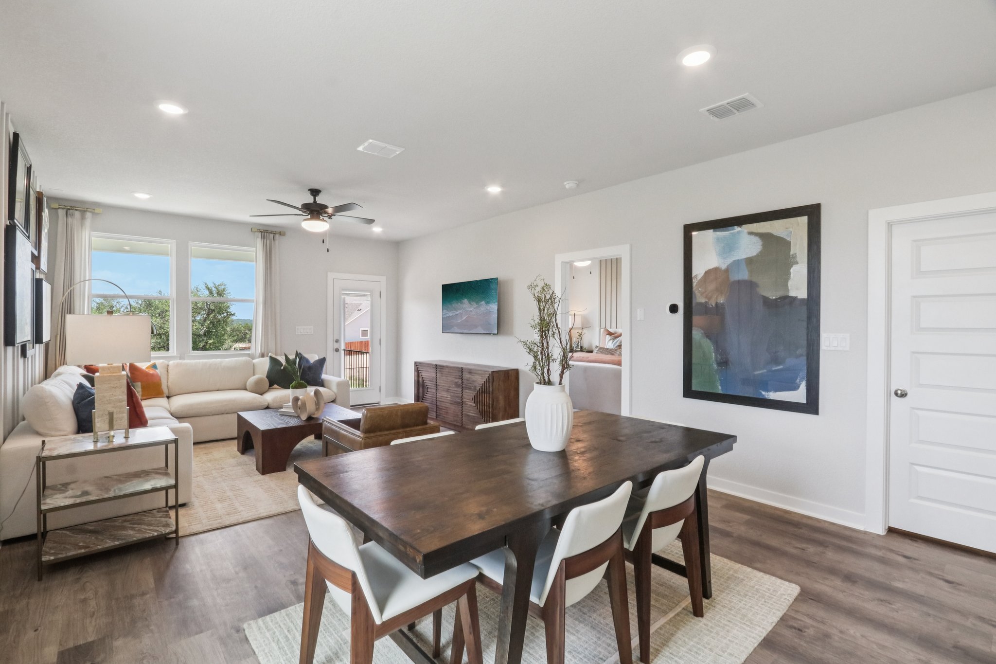A dining room with a table and chairs.