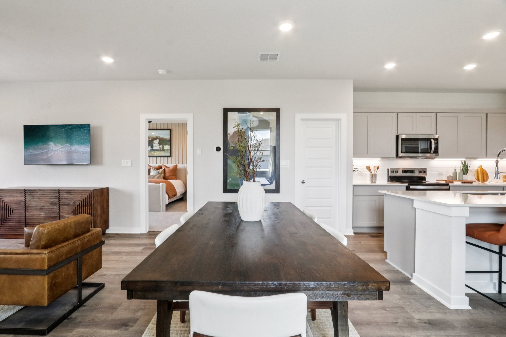 A living room with a table and chairs.