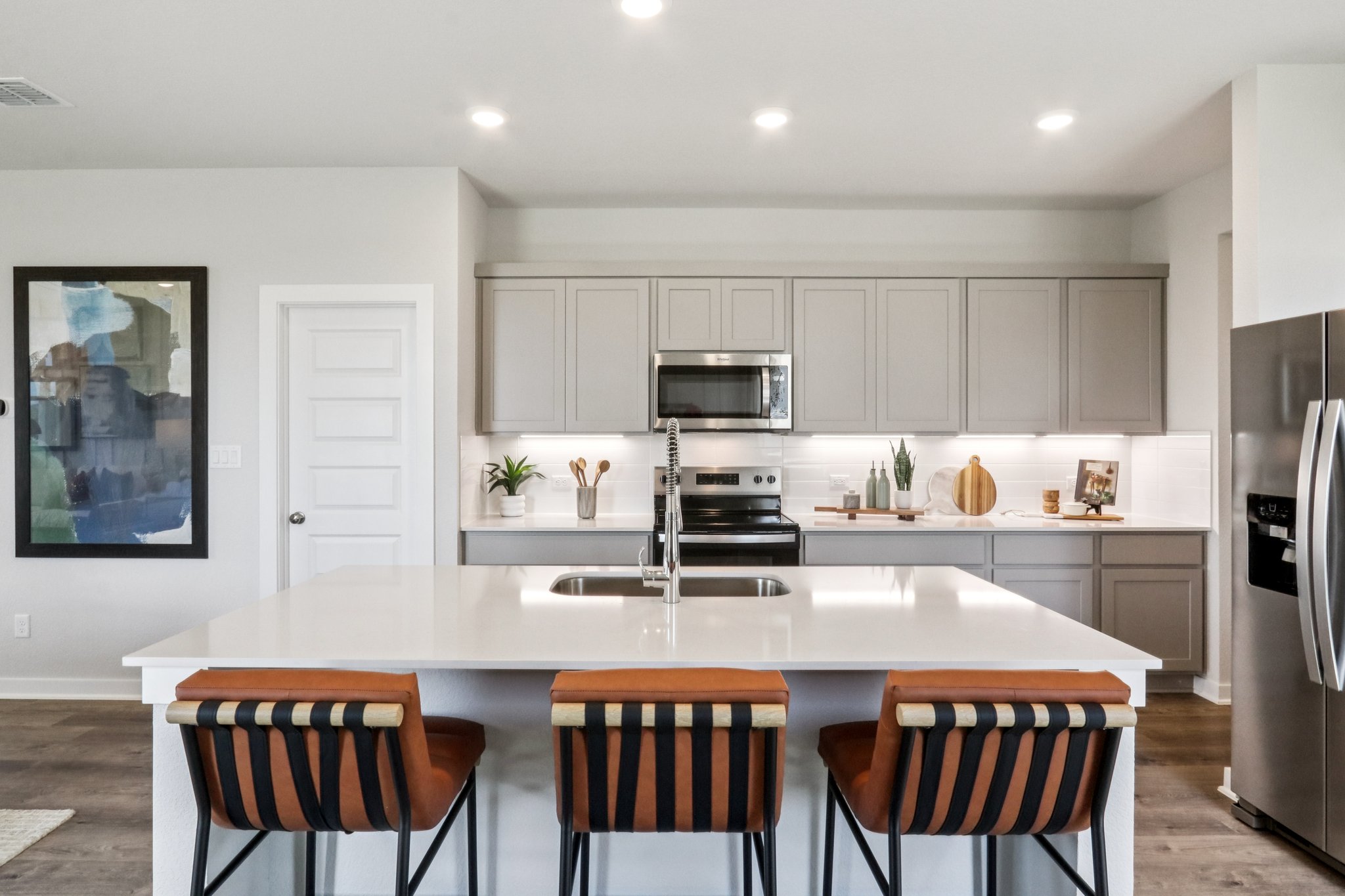 A kitchen with white cabinets.