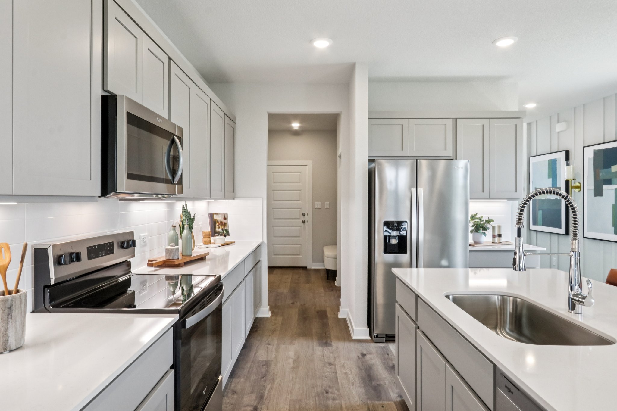 A kitchen with white cabinets.